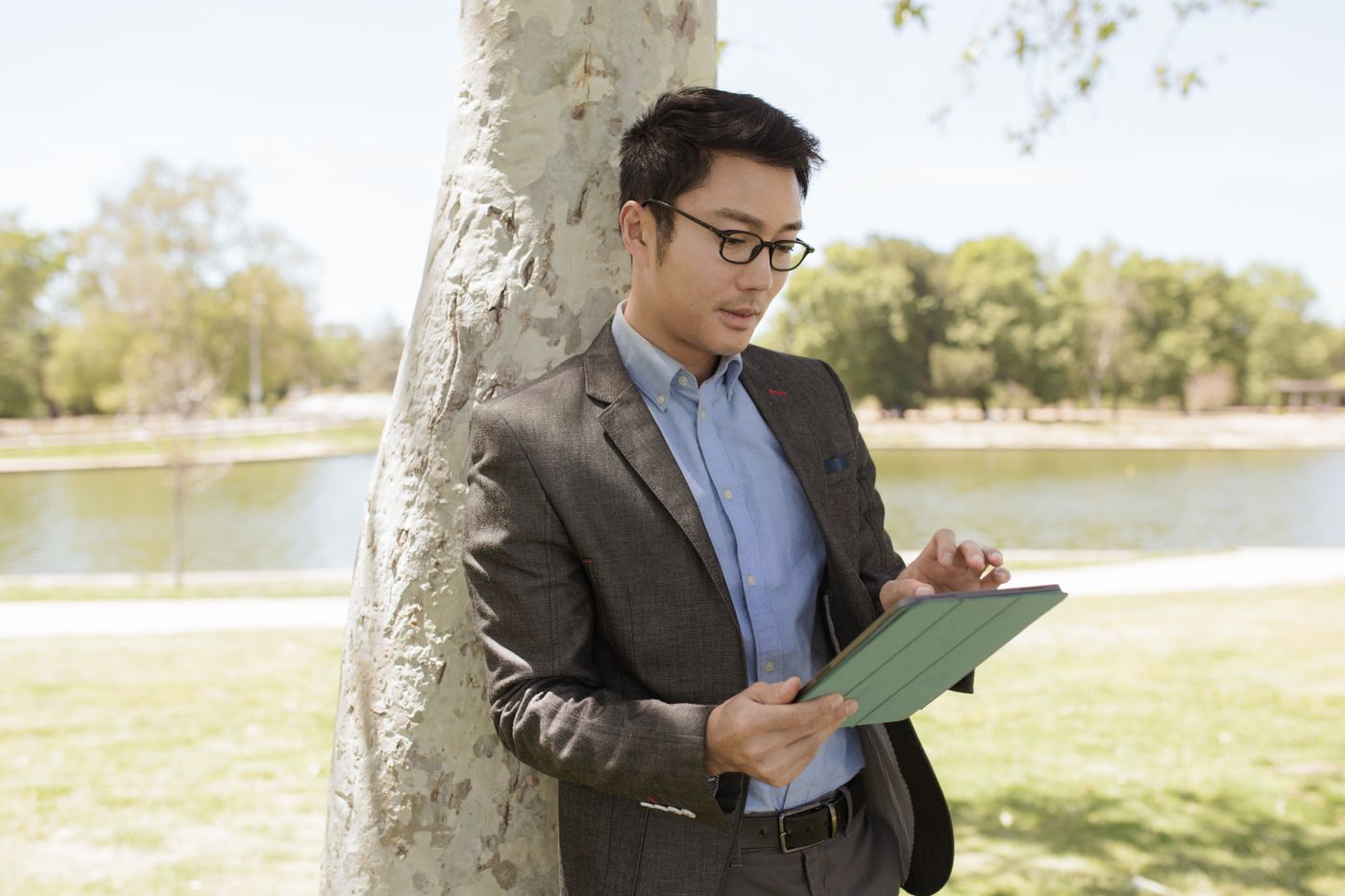 A member of staff checking a tablet outdoors