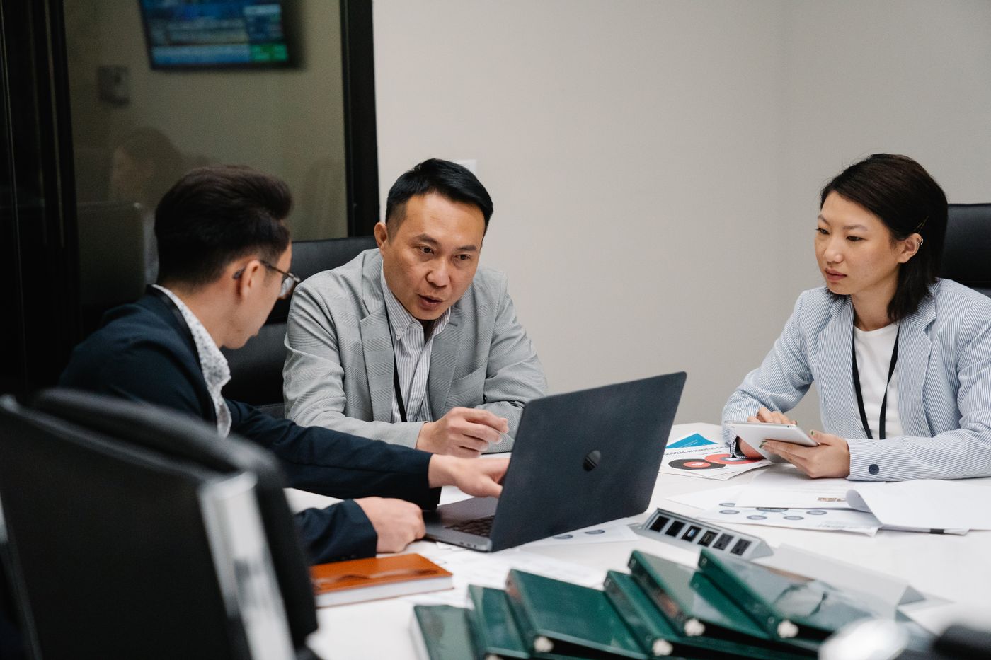 Colleagues planning around a table with laptops