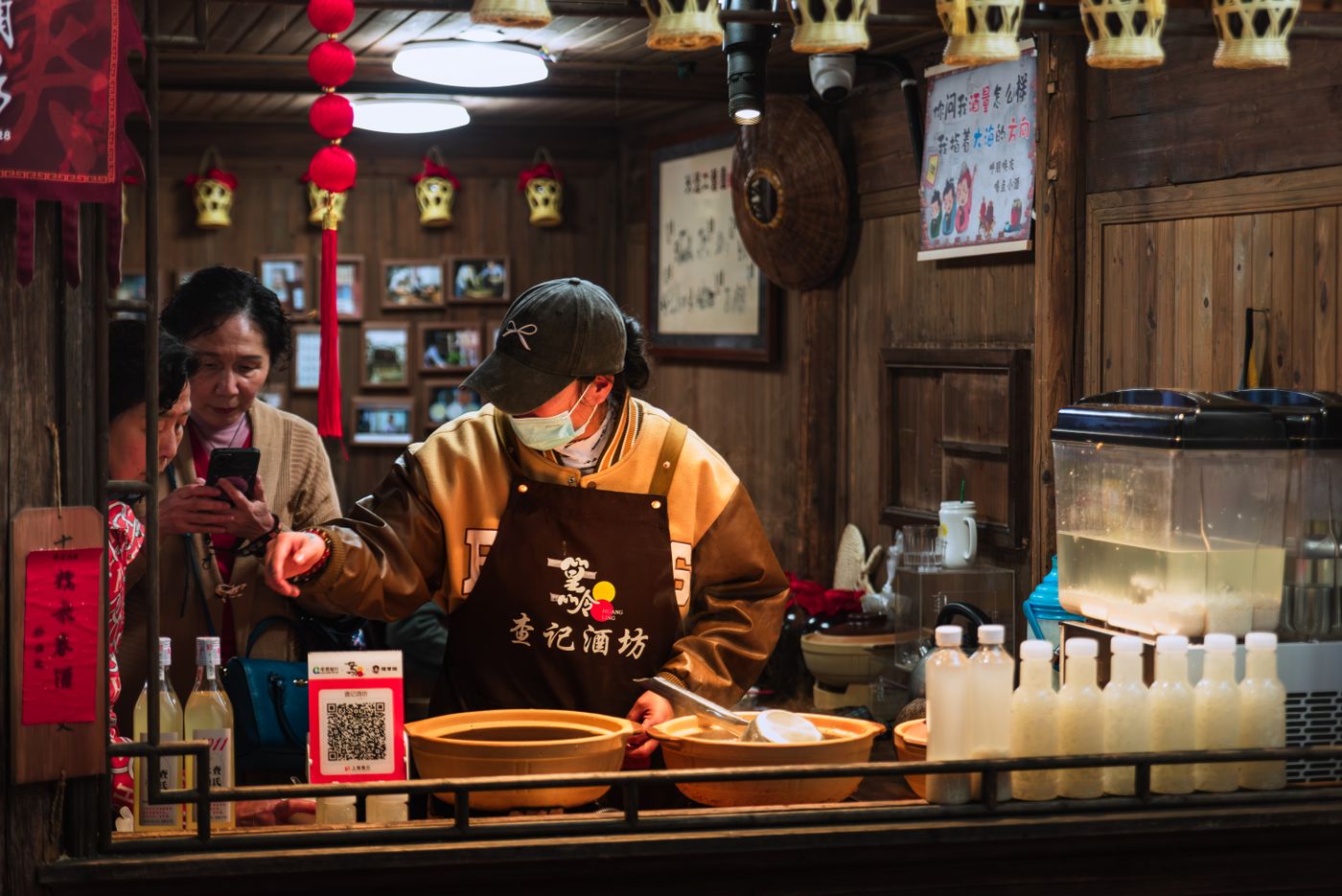 A food stall with a QR code for payment on the counter